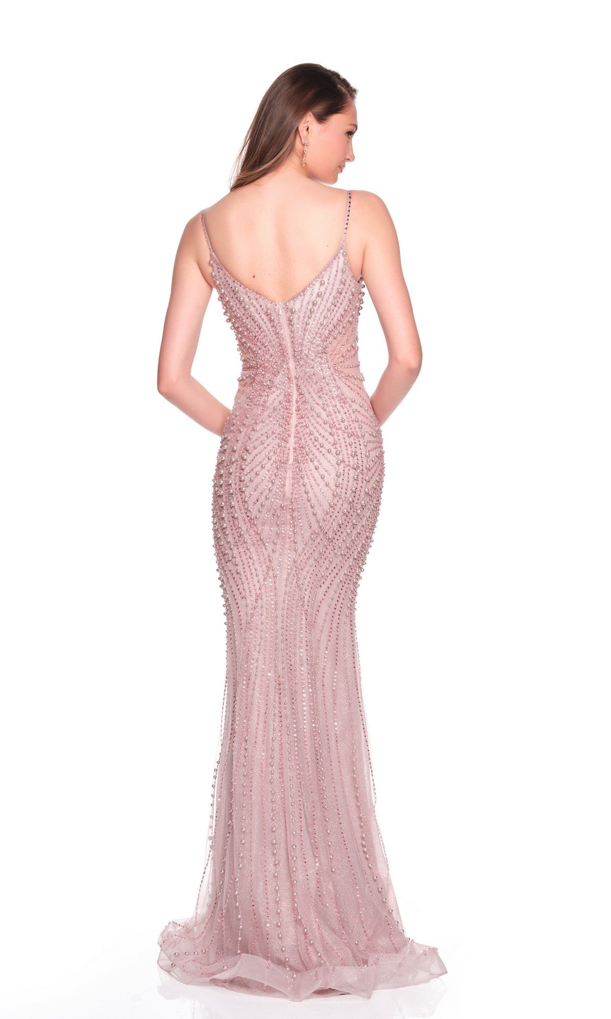 A woman faces away in the Dave and Johnny 12805 long prom dress—a sleeveless, light pink tulle gown adorned with bead embellishments and pearl appliques—against a white background.